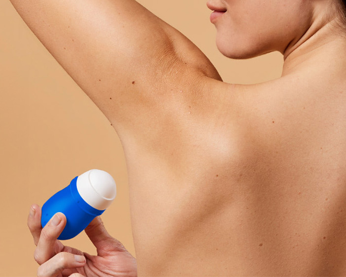 woman using deodorant